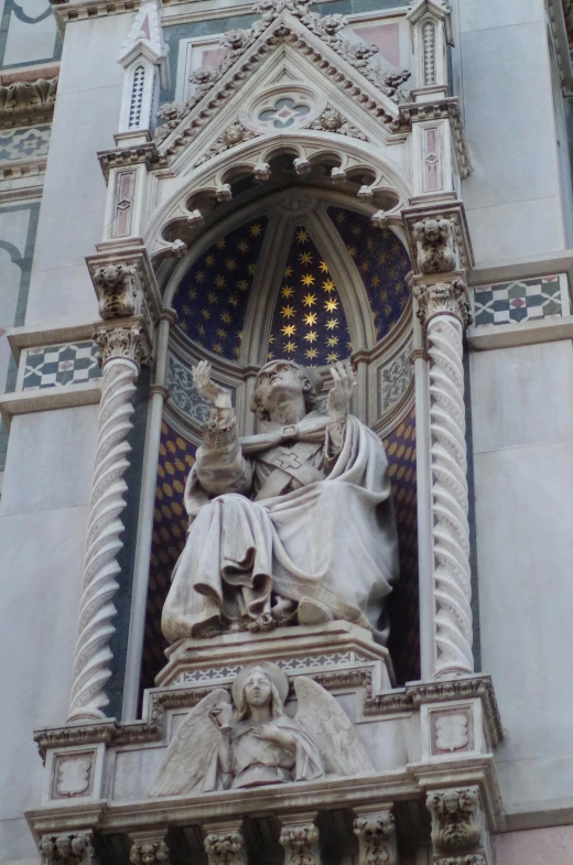 an elaborate statue is above the entrance to a building