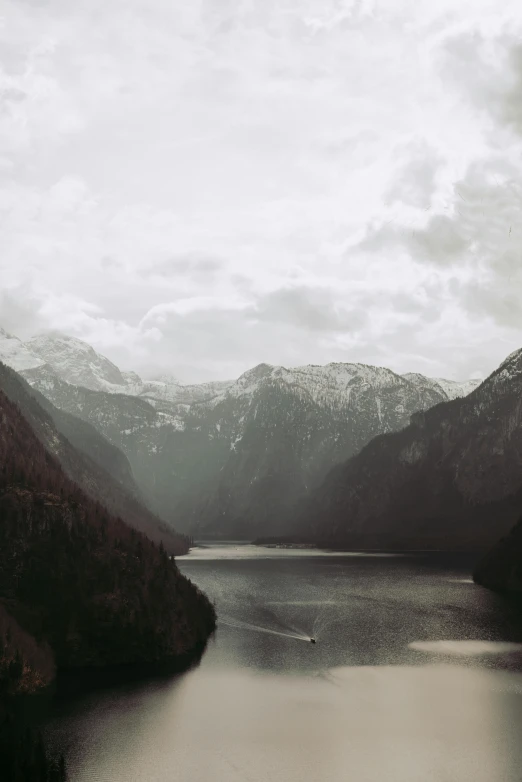 a mountain lake with snow on it's summit