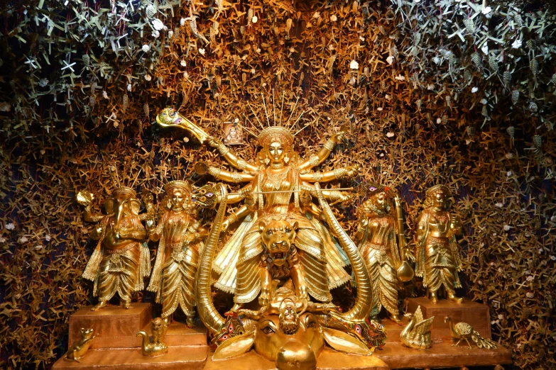 the golden statue has many gold ornaments on it