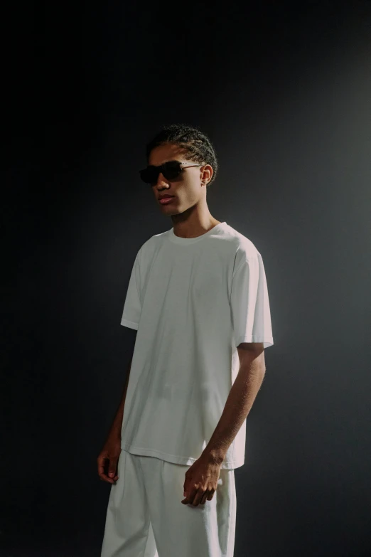 man standing in a dark room with a black background