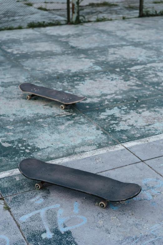 a couple of skateboards lying in a parking lot