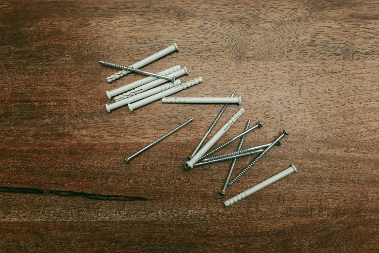 several small metal nails laid out on the floor