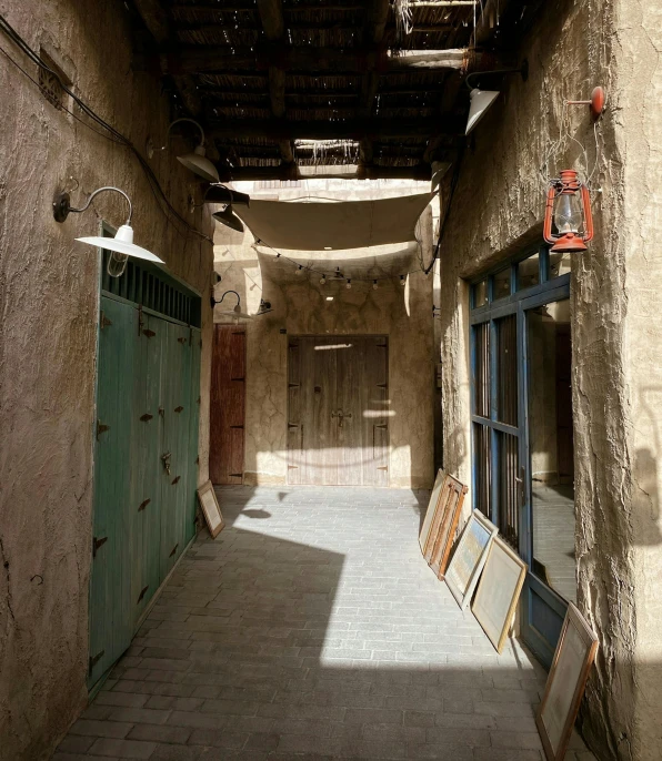 a narrow alley in a village with old doors