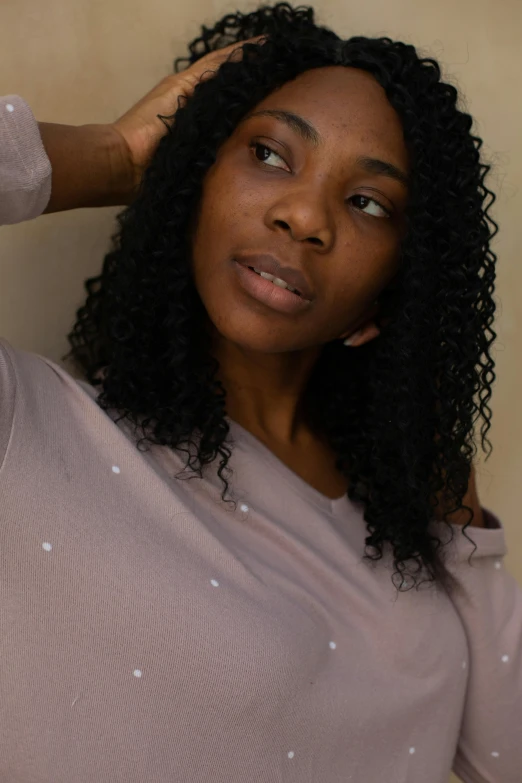 a close up of a woman touching her hair