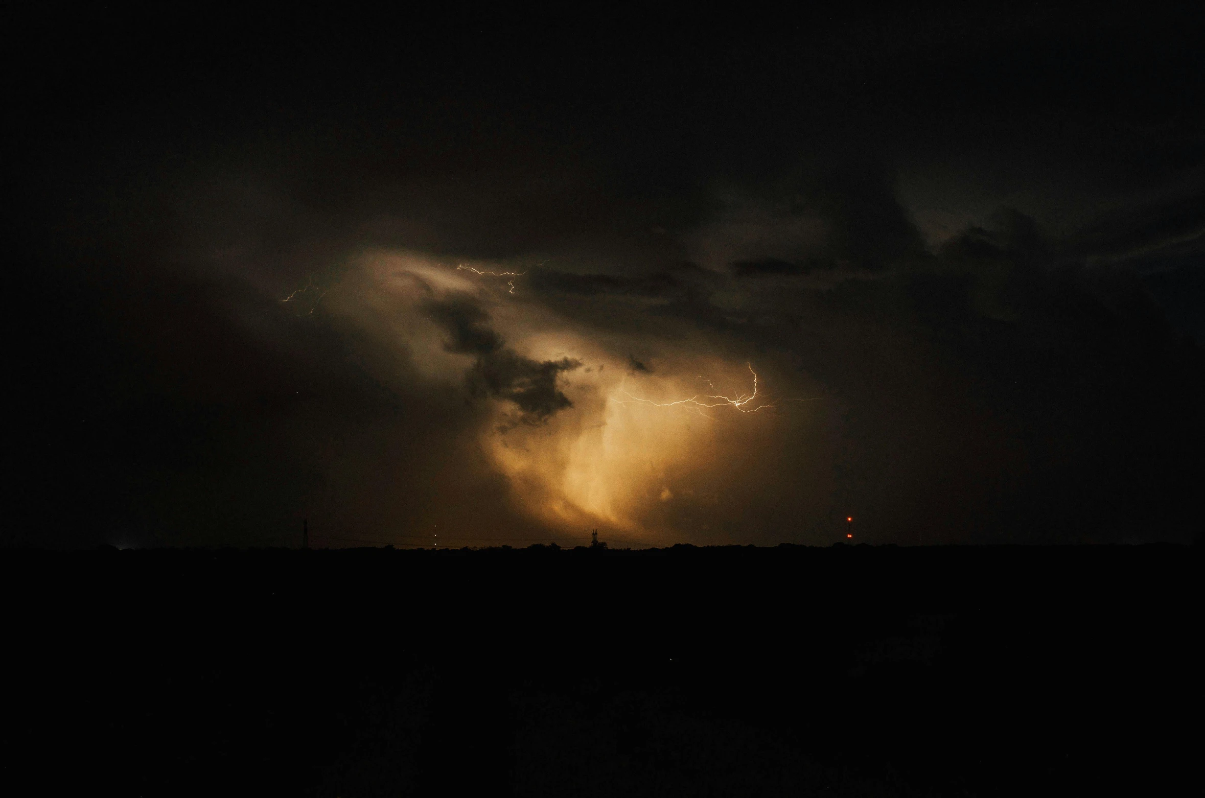 storm clouds at night with a bus in foreground