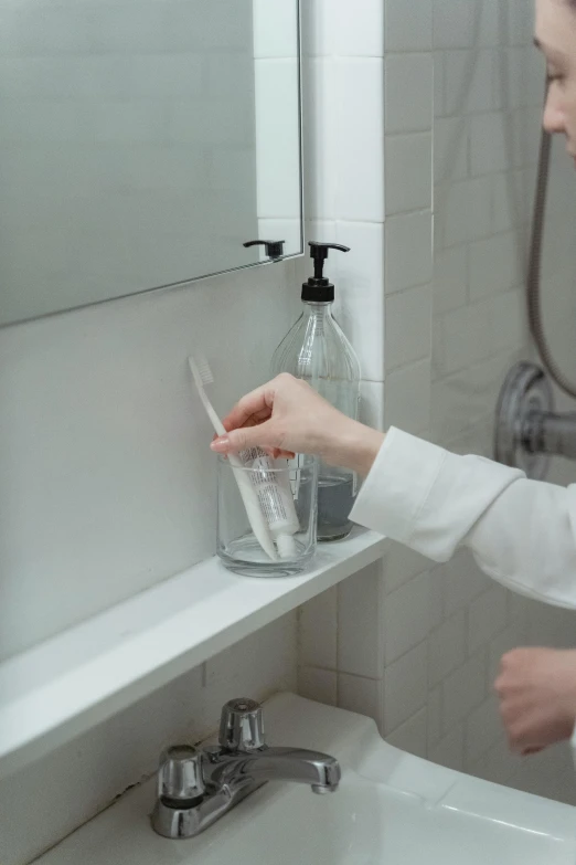 the lady is holding tooth brushes while cleaning her mouth