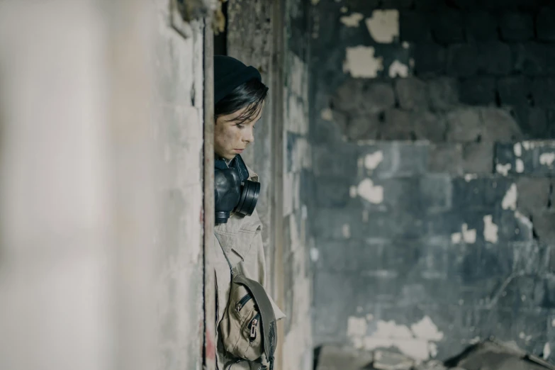 woman with headphones leaning on a wall