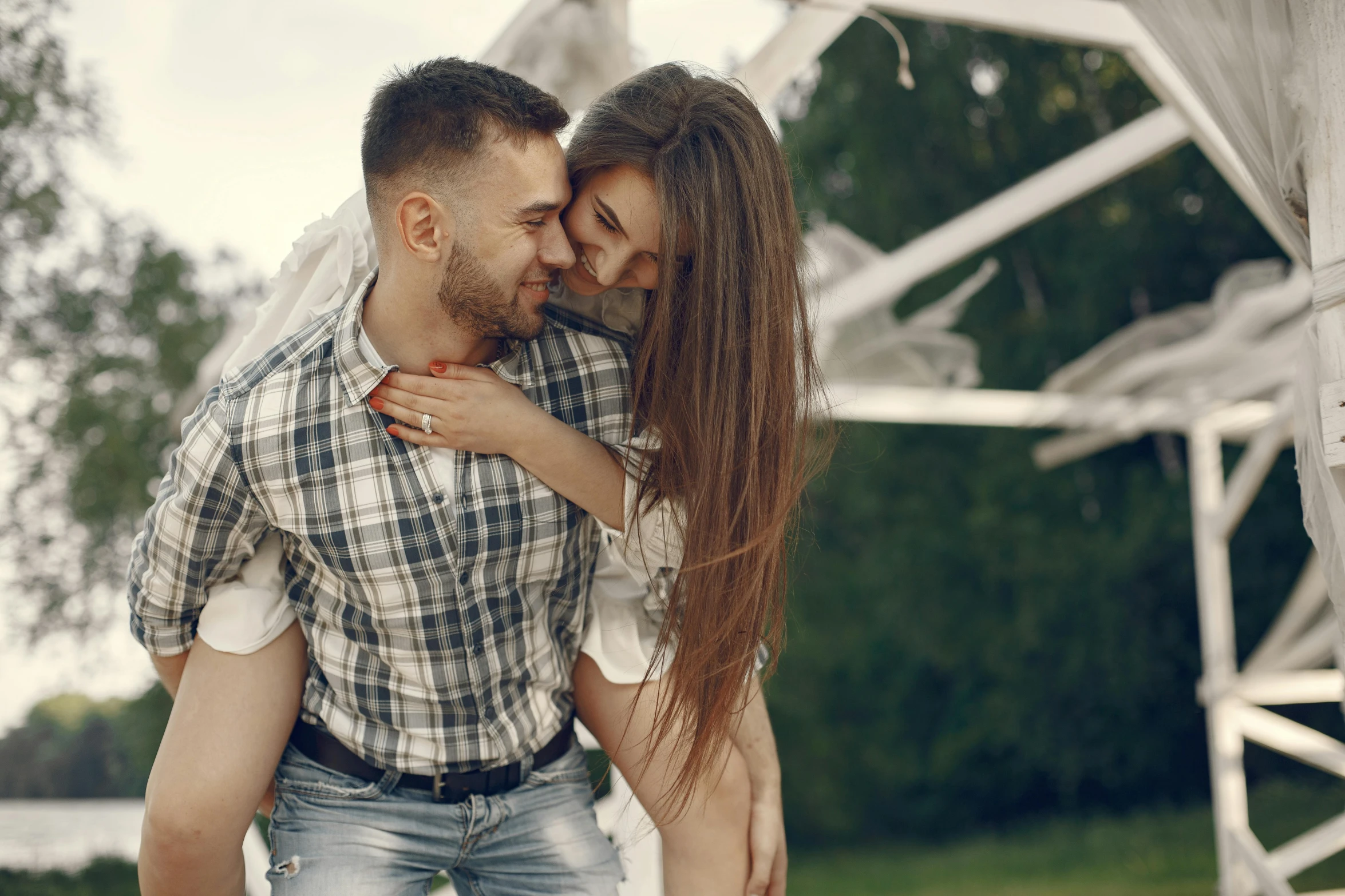 a man and woman sharing an emce in the park