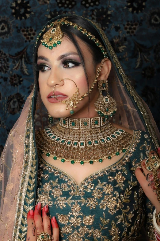 the indian woman is wearing an elaborate outfit and jewelry