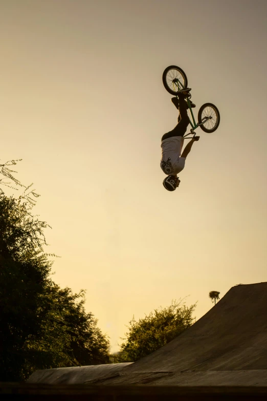 a man doing tricks on a dirt bike