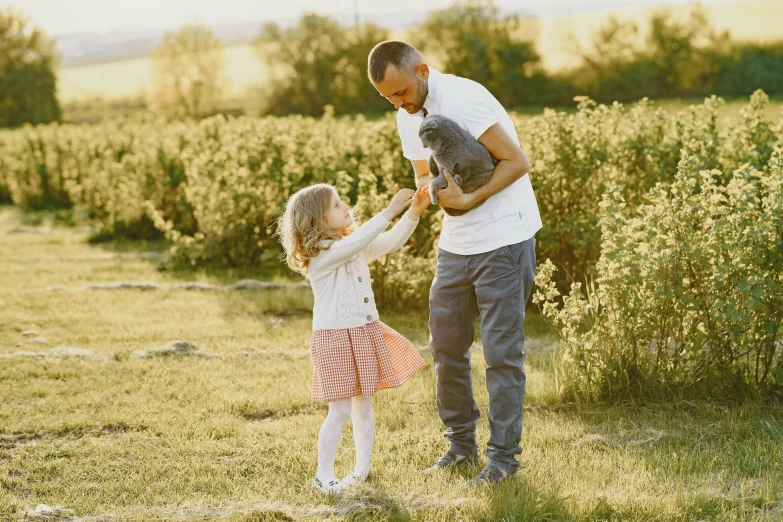 a  playing with a father's hand as they hold him