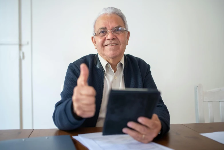 a man that is sitting at a table