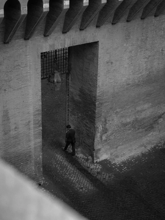 black and white po of man in doorway of building