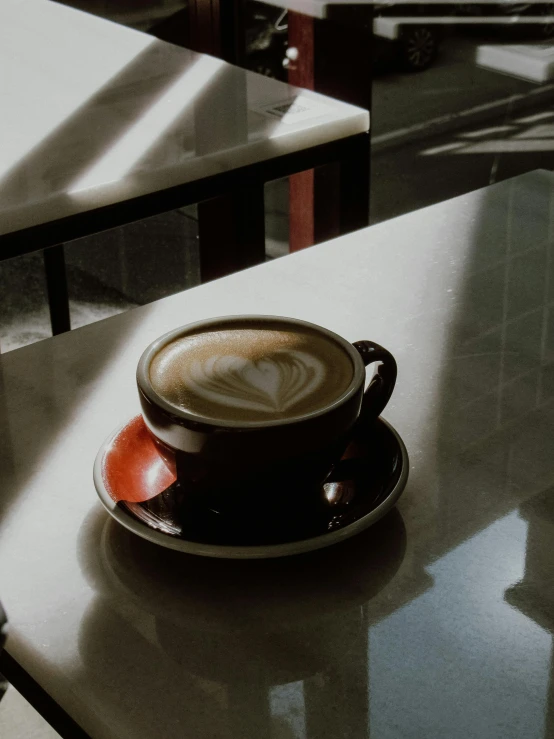 cup of coffee sits on a table in a restaurant