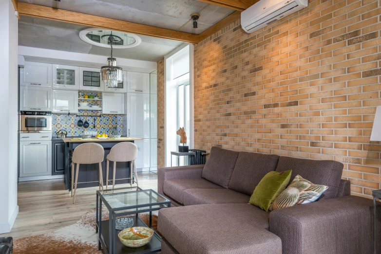 a small living room with brick walls and wood floors