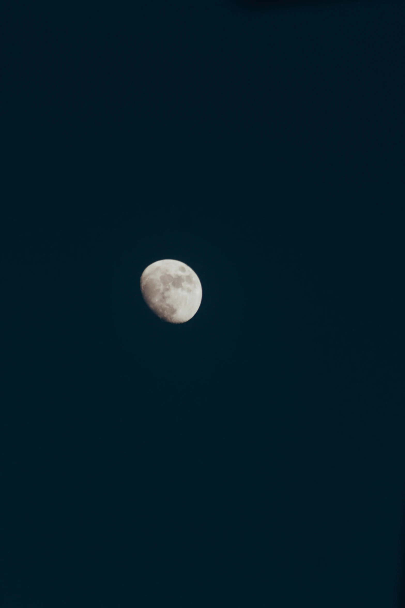 the moon is almost hidden by the clouds