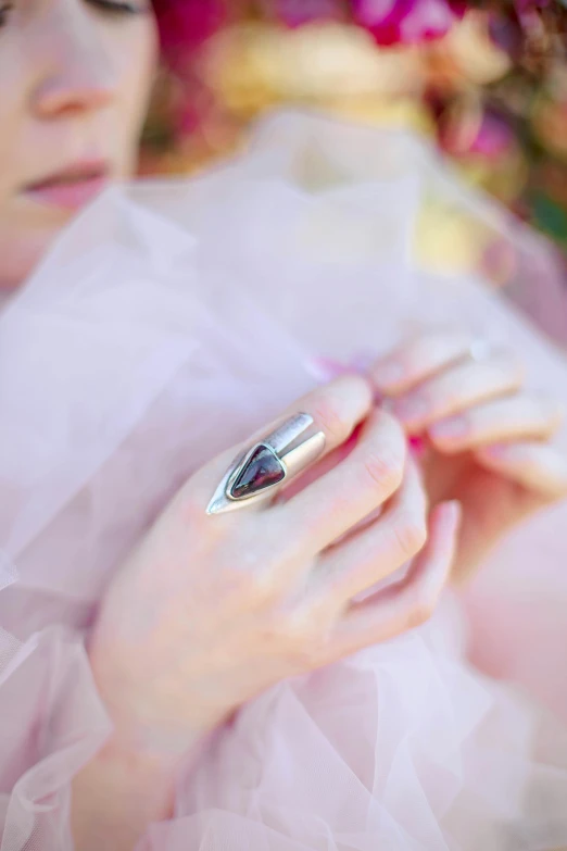 a woman with dark eyes holds an item in her hands