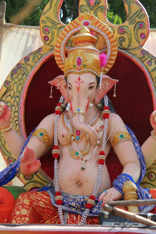 a statue of a hindu god with big  and two rings