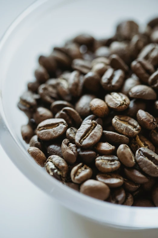 the coffee beans have been roasted in a white cup