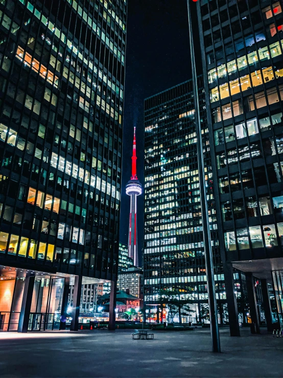 some tall buildings lit up in the night sky