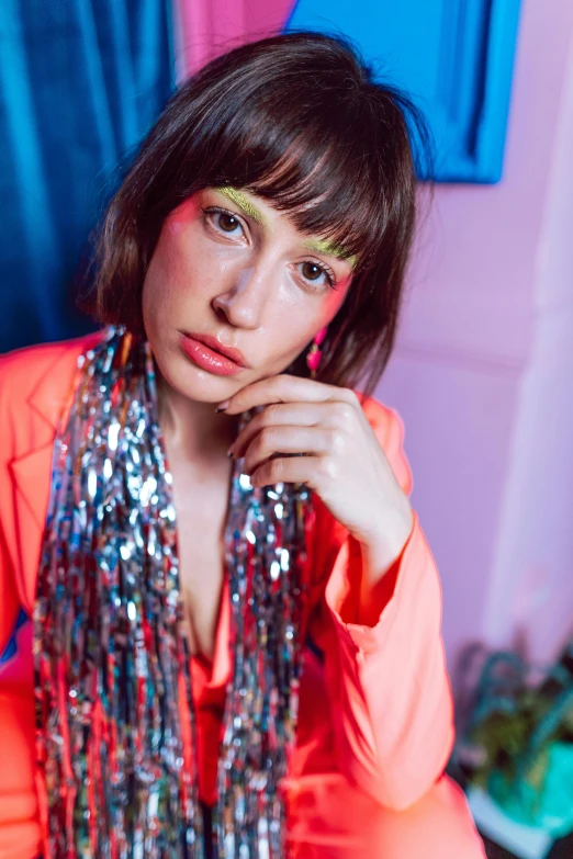 a woman poses in a dress in a colorful room