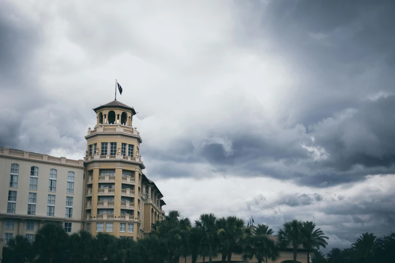 a large white and gold building under dark skies