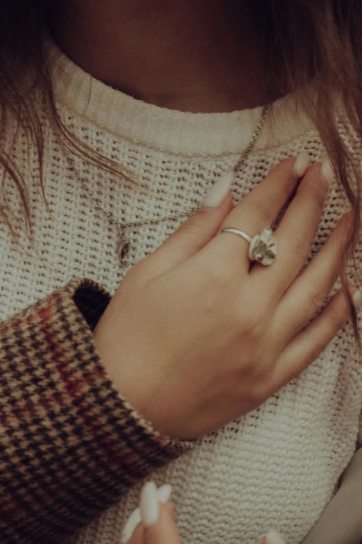 woman with ring on her finger standing up