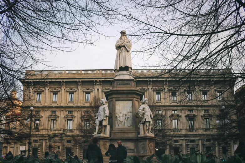 a statue of a woman stands in front of the building