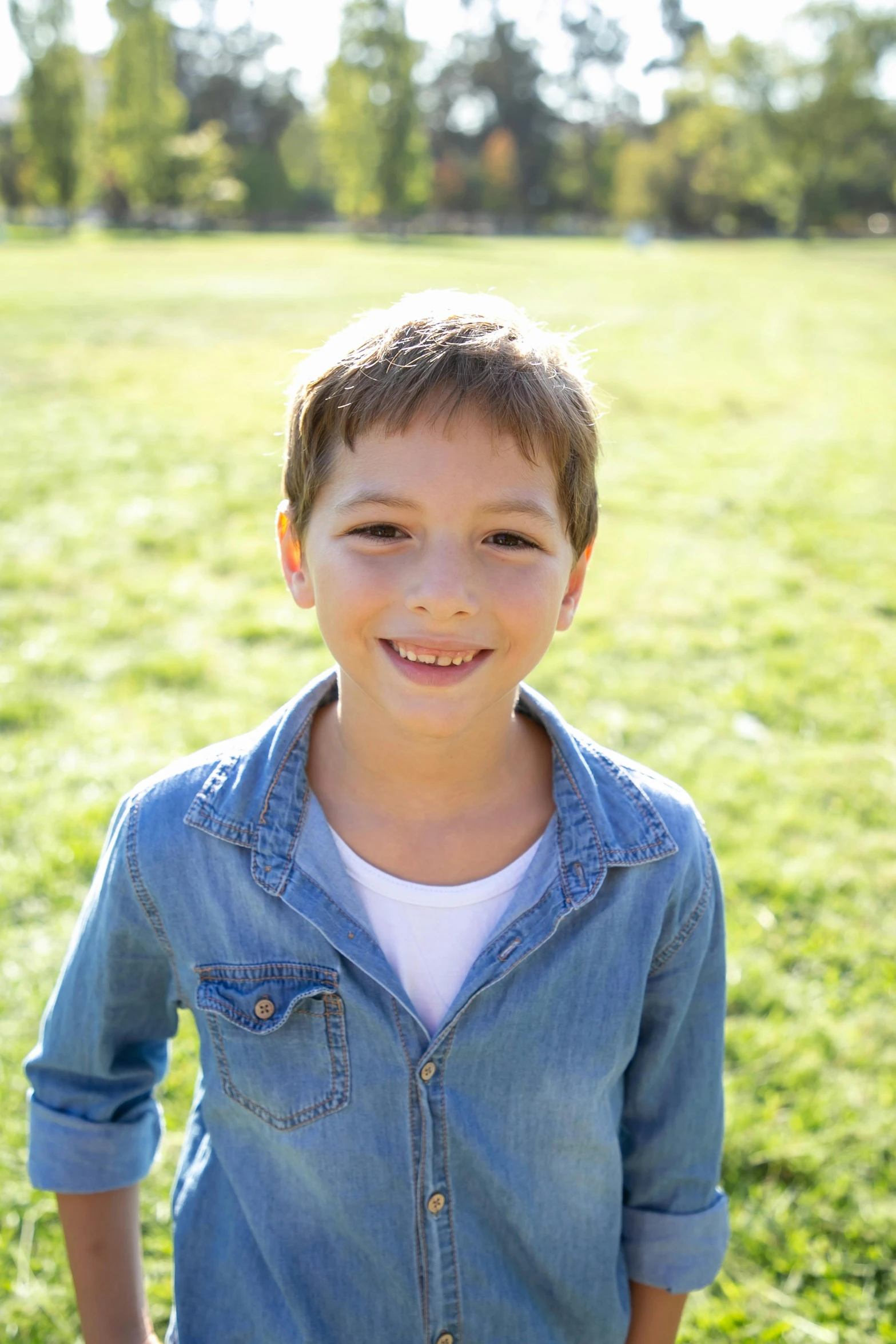 a little boy that is standing in the grass