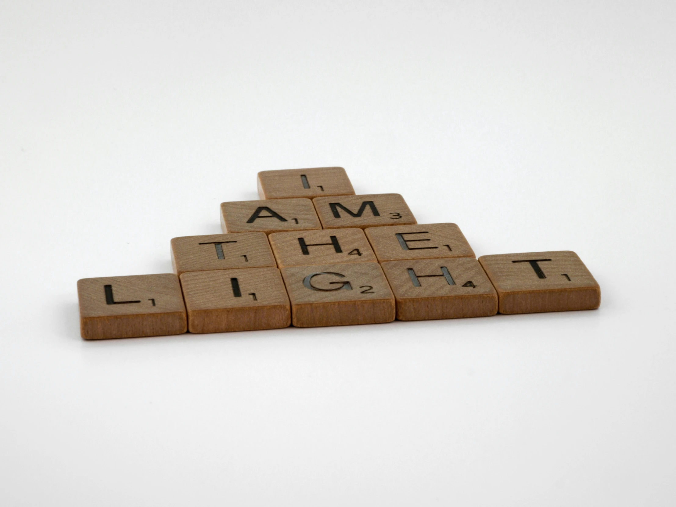 wooden blocks with words that spell out light and a person