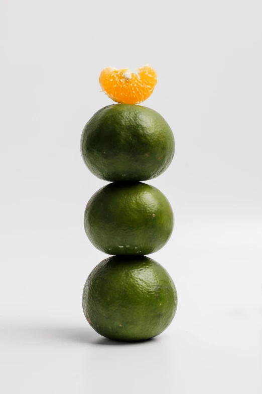 a stack of stacked limes with an orange