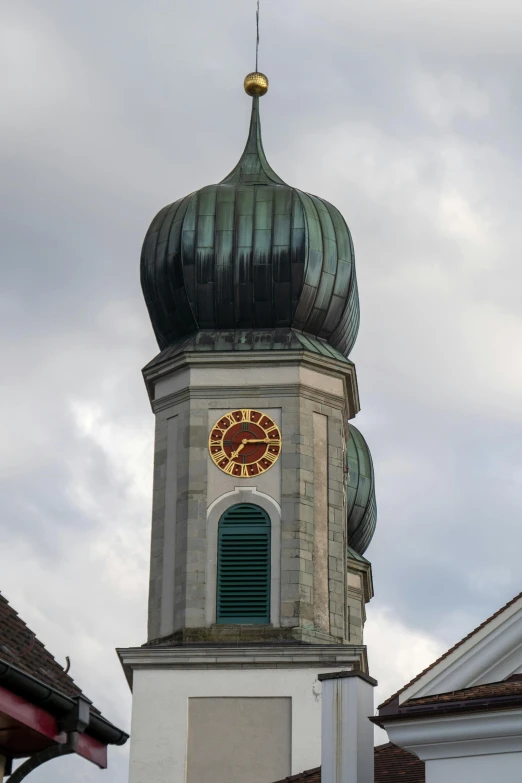 a tall steeple has a clock on it