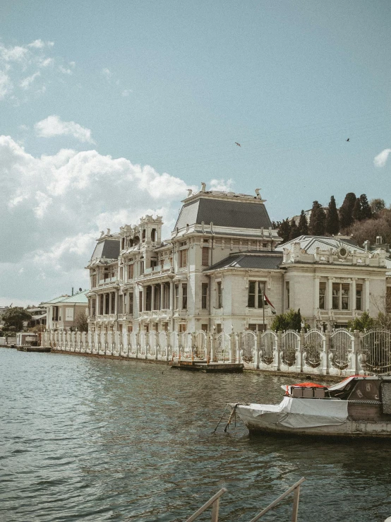 a body of water with a long building on top and a boat in the middle