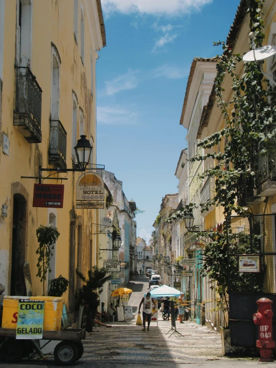 a narrow street is lined with yellow building