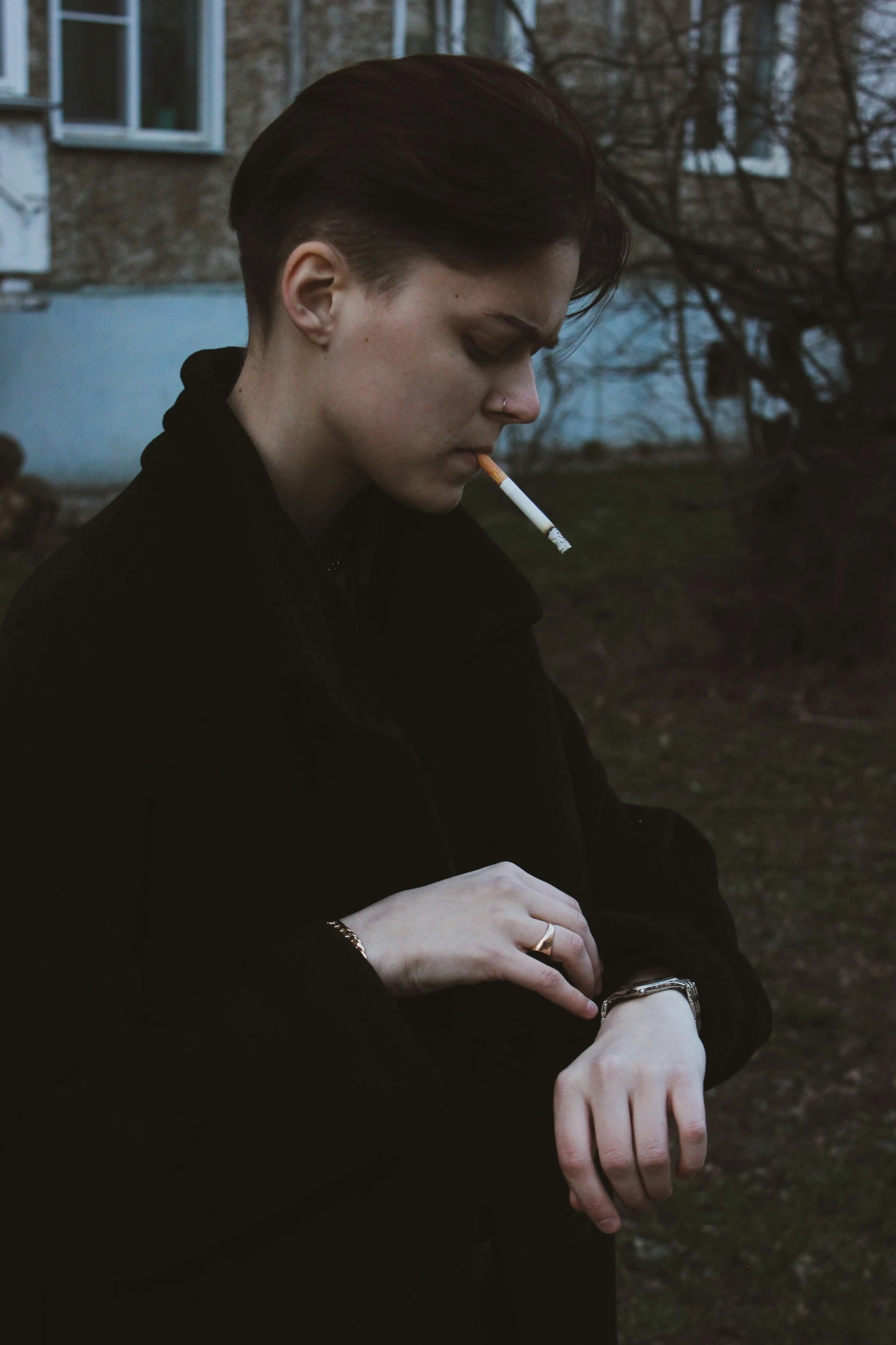 a woman smoking an cigarette in the city