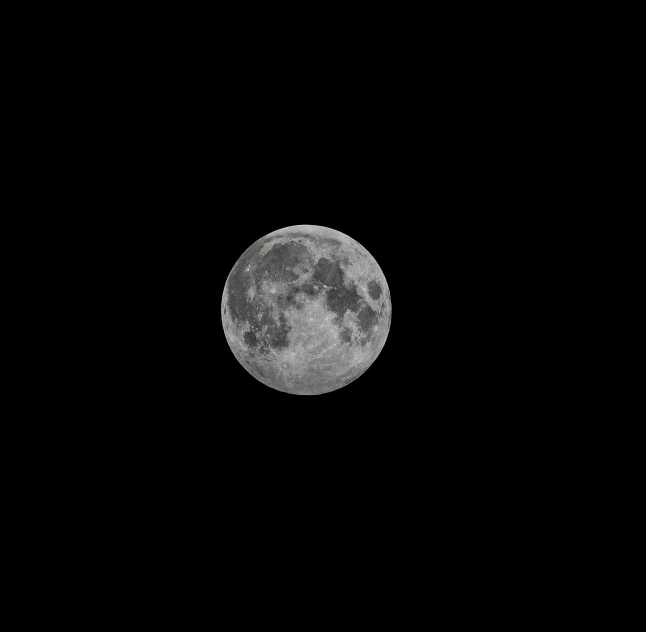 a half moon seen from a distance, showing the dark side of the moon