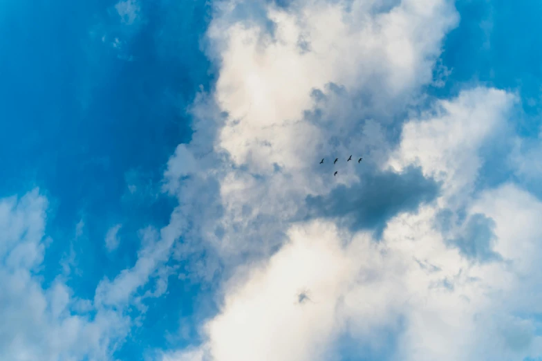 an airplane flying through the clouds and sky