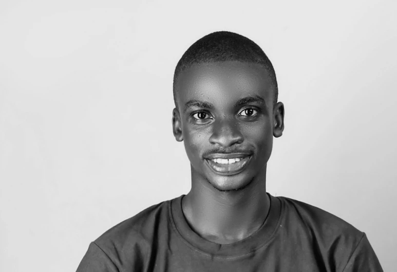 the black and white image shows a smiling young man