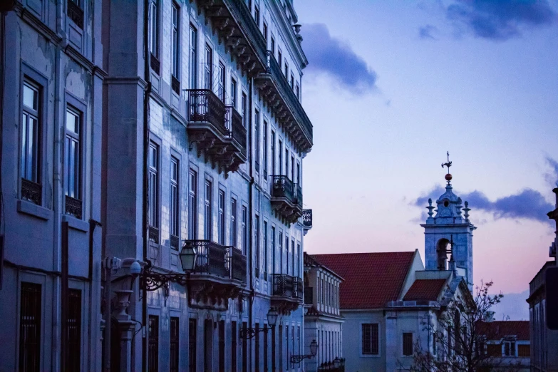 a church tower is seen against an evening sky