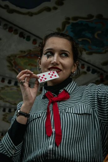 an image of woman with card in her mouth