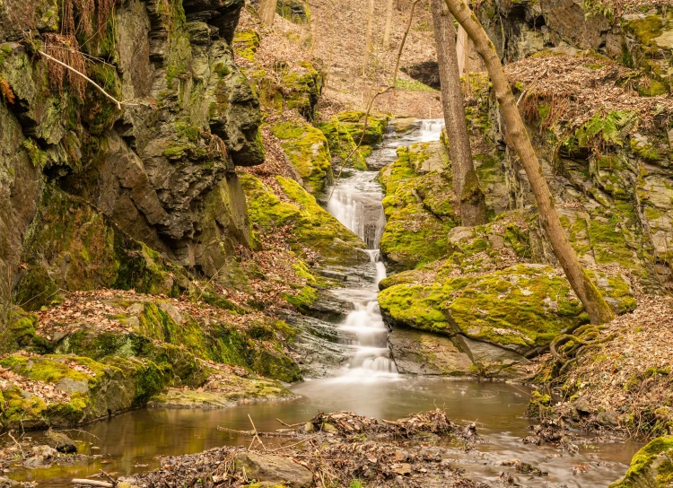 water that is falling out of a small waterfall