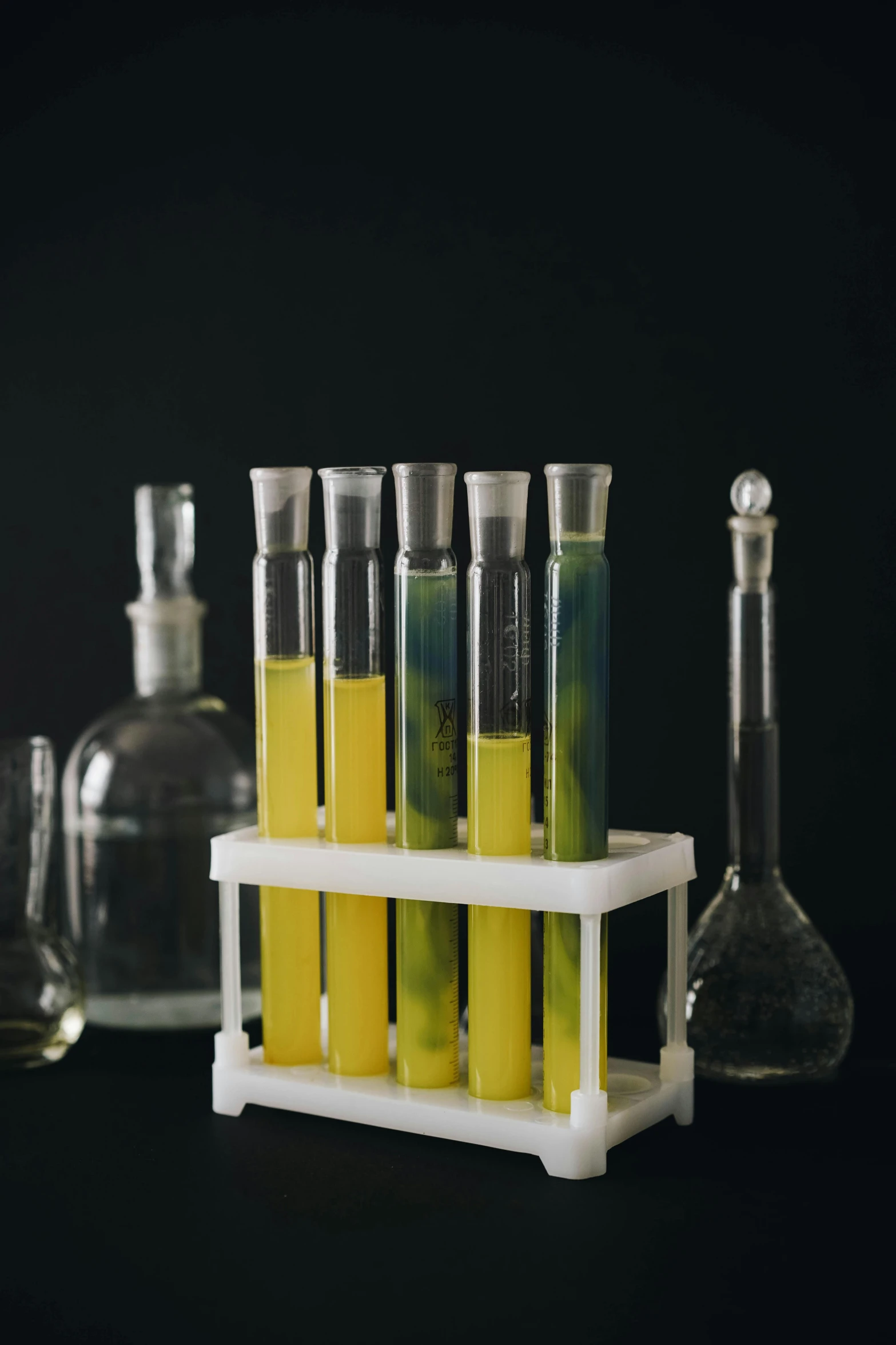 an assortment of glassware containing chemical substances on a shelf