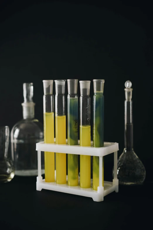 an assortment of glassware containing chemical substances on a shelf