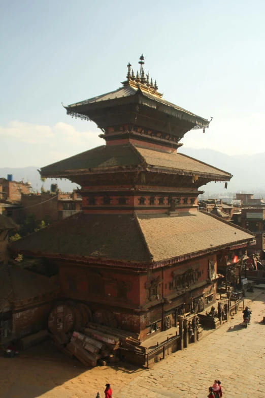 the large pagoda on top of the building is very tall