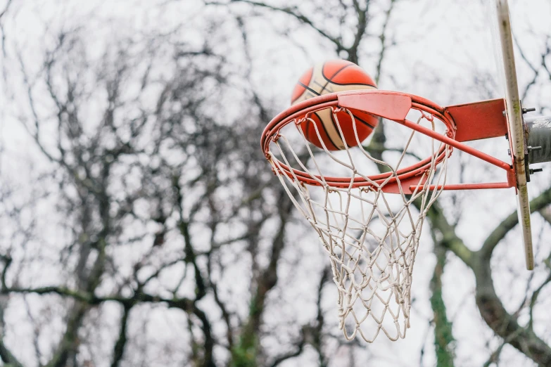 a basketball that has been stuck in the net