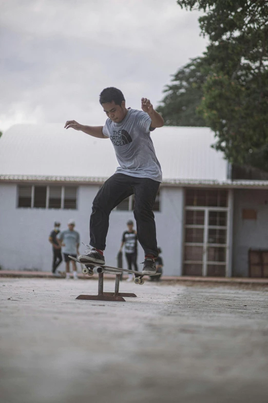 a boy on a skateboard jumping a stand