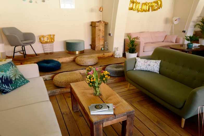 a living room with furniture, and flowers on the coffee table