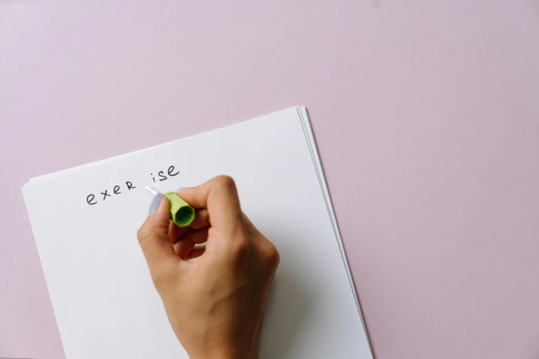 a hand that is holding a piece of paper that has some writing on it