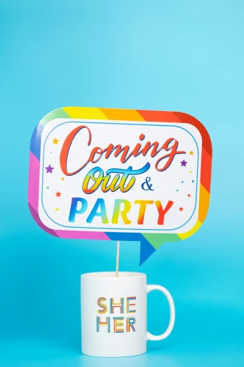 a mug and sign with the words coming out & party on it