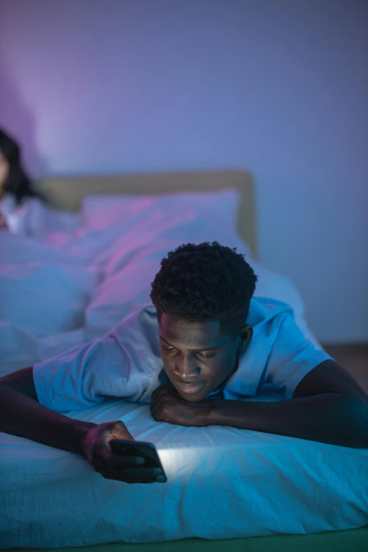 two people in the middle of a bed in a dark room